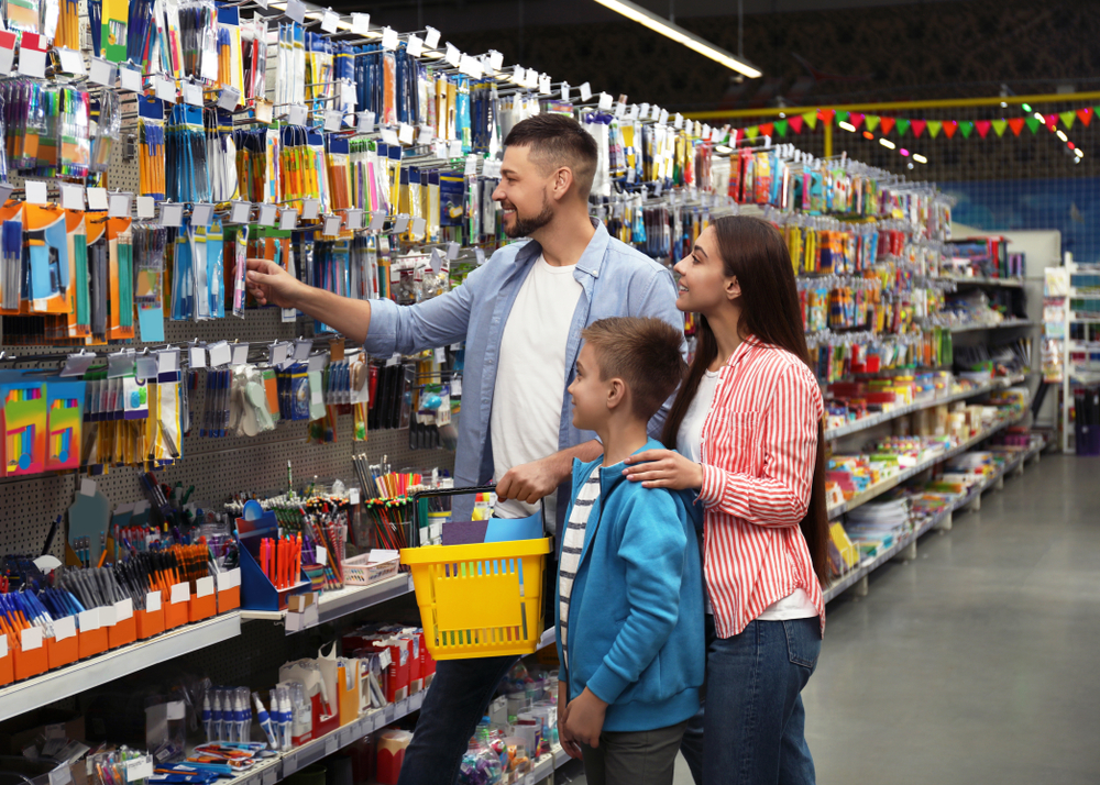 Family,with,little,boy,choosing,school,stationery,in,supermarket