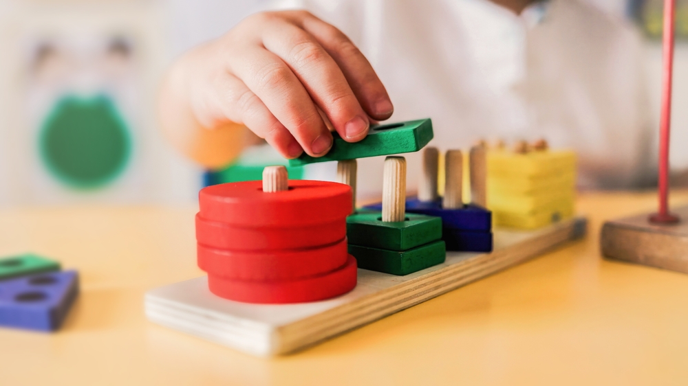 Kid,playing,with,wood,toys,at,pre,school,classroom.,kindergarten