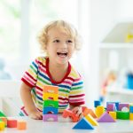 Kid,playing,with,colorful,toy,blocks.,little,boy,building,tower