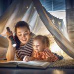 Family,bedtime.,mom,and,child,daughter,are,reading,a,book
