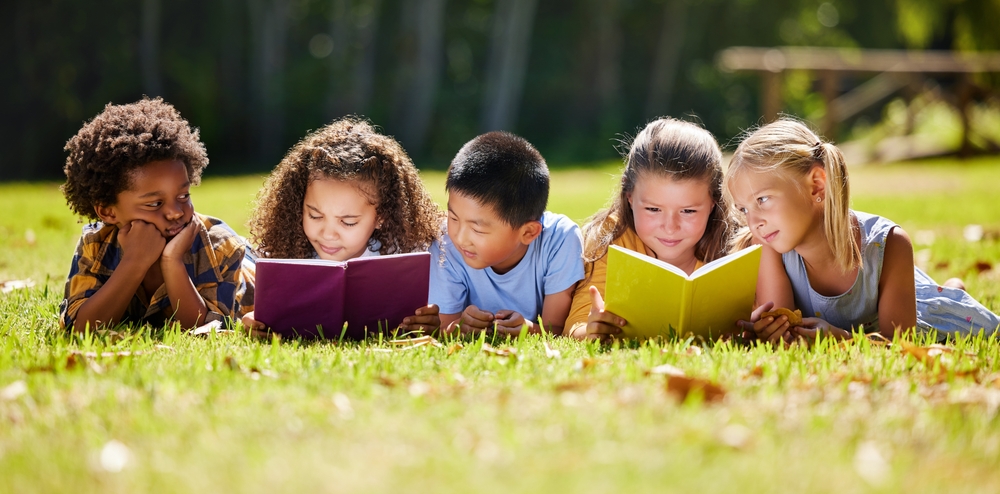 Children,,books,and,lying,in,park,with,friends,,learning,or